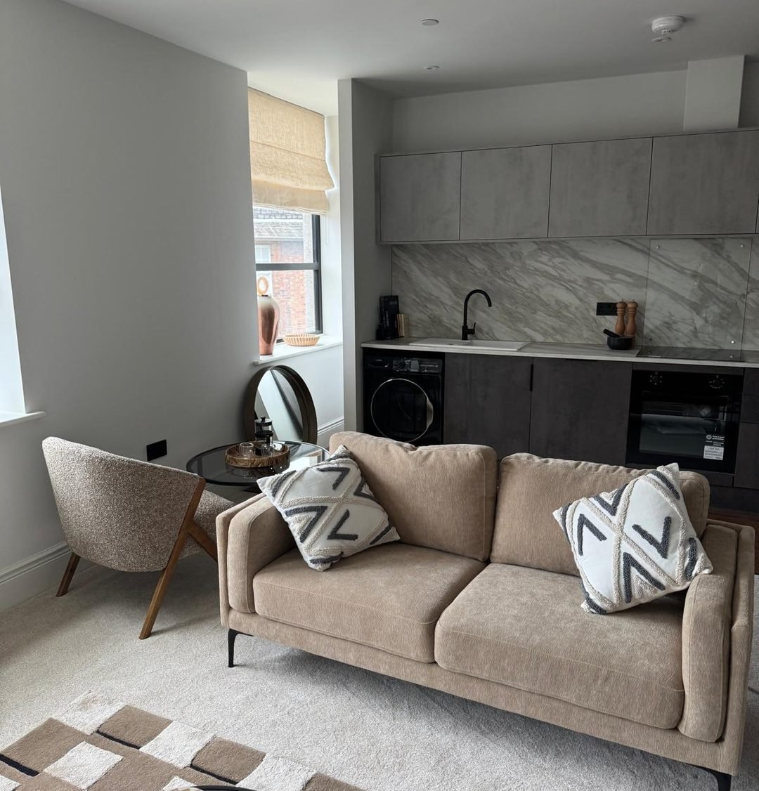 Open plan living room and kitchen with freshly painted walls, ceiling and woodwork