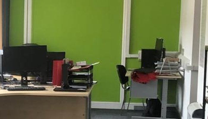 Refurbished office with repainted walls, ceiling and a green feature wall